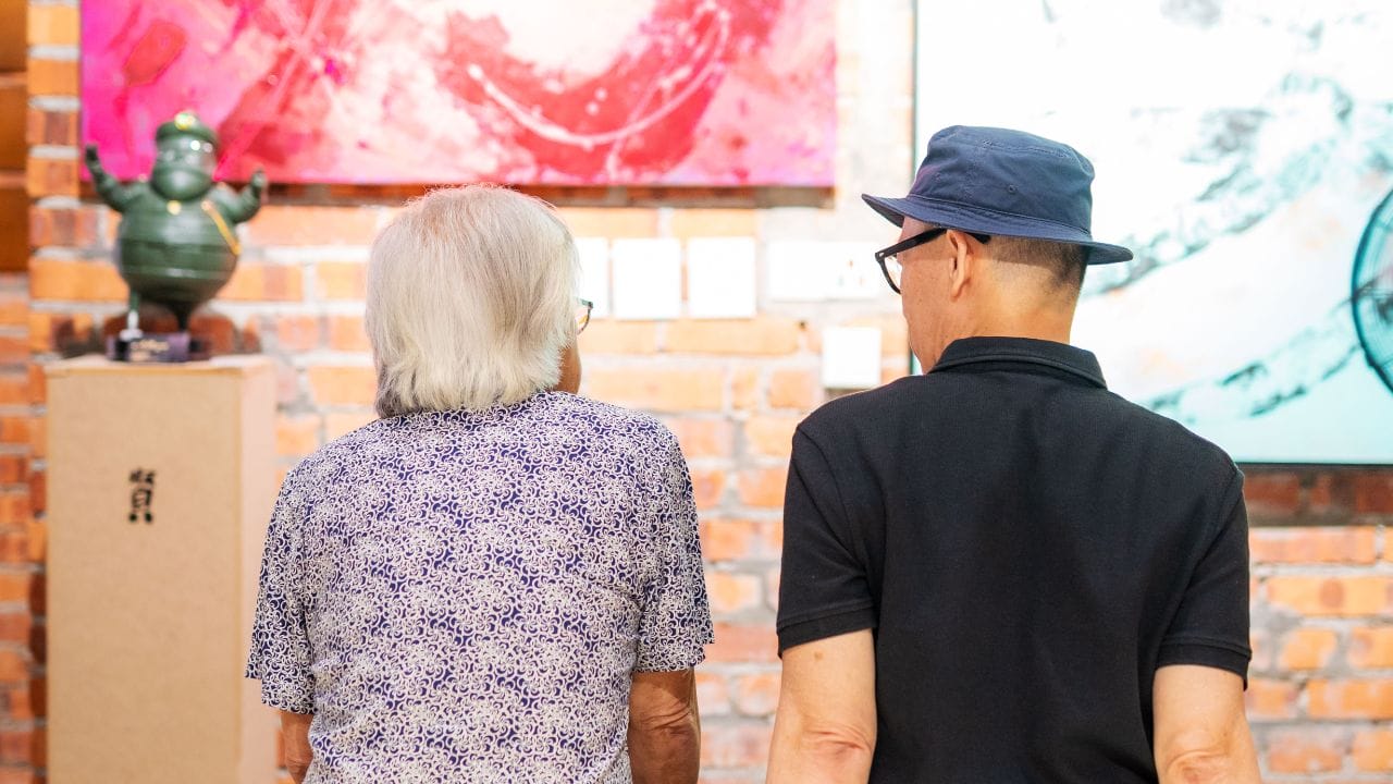 Guests turn their gaze on Michelle Yap’s canvas pieces, many of which are identifiable through the calligraphy-like strokes.