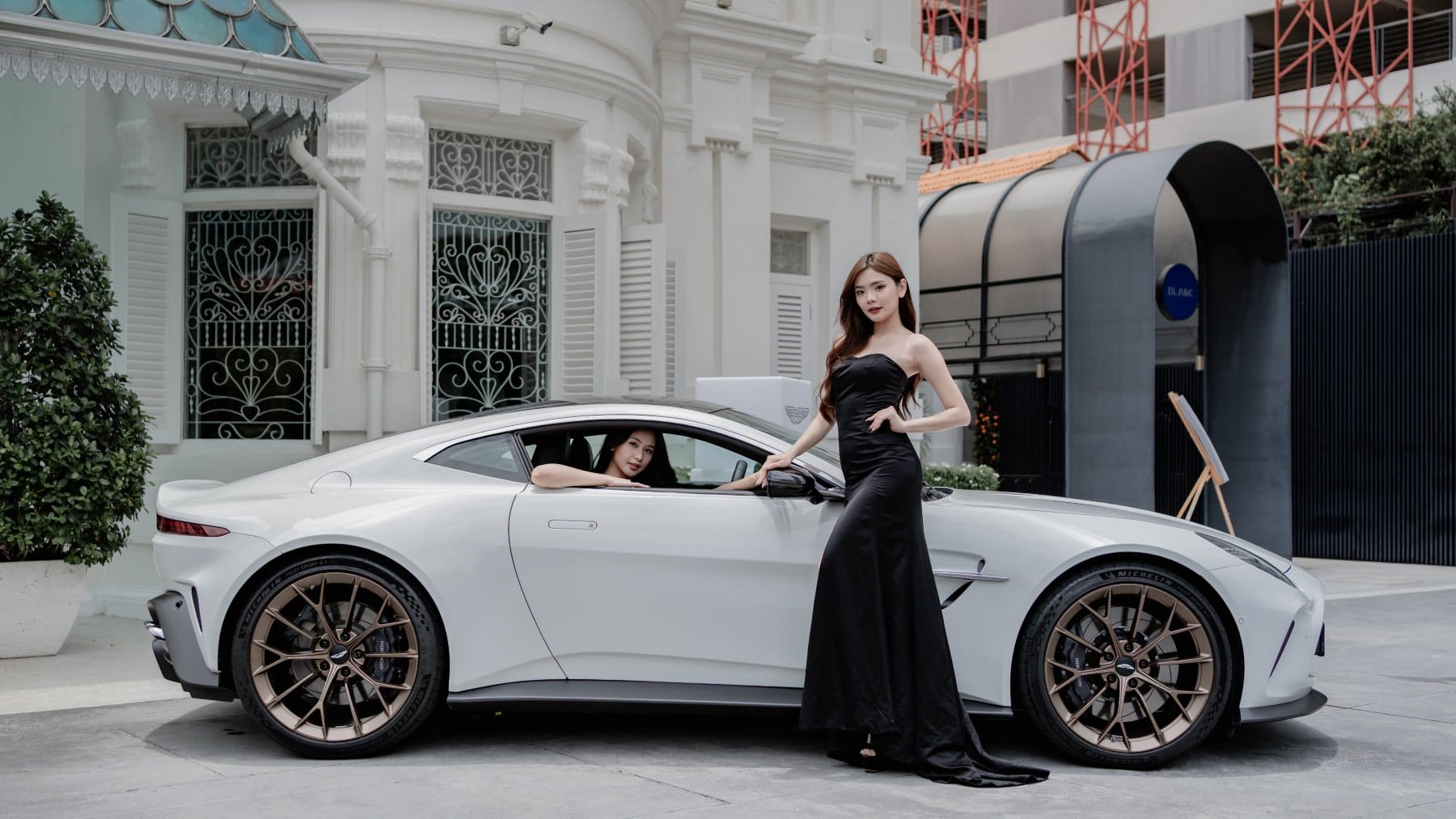 Models with the Aston Martin Vantage.